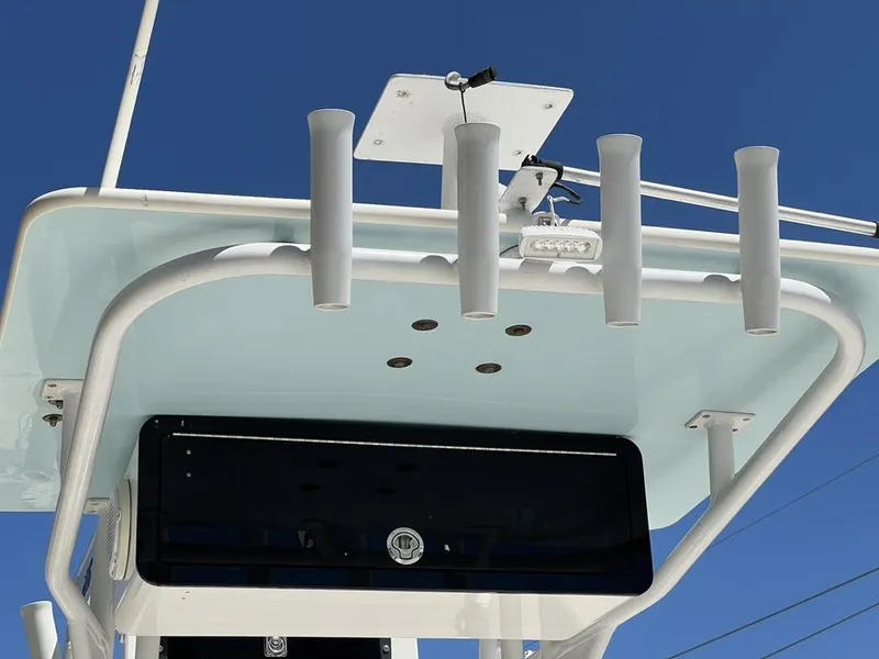 Slide: The Image of Avenger AV 26 boat roof with rod holders, 2016 model, against clear blue sky. - 15
