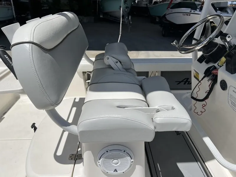 Slide: The Image of 2016 Avenger AV 26 boat interior with white cushioned seating and steering wheel. - 3