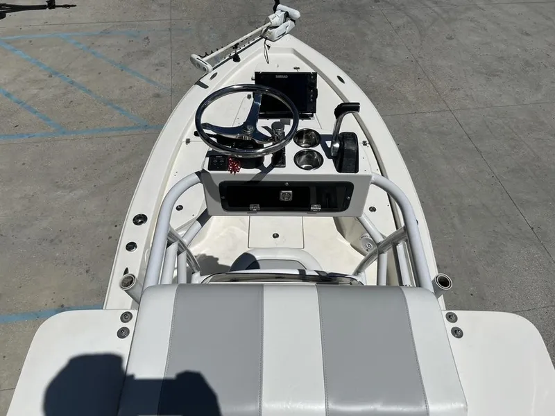 Slide: The Image of 2016 Avenger AV 26 boat cockpit with steering wheel and controls, parked on concrete. - 5