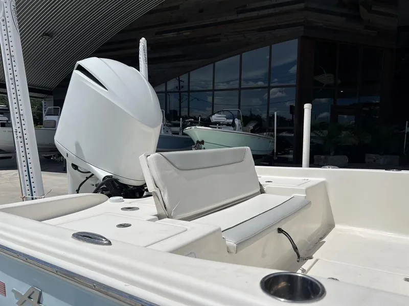 Slide: The Image of 2016 Avenger AV 26 boat with white seating and powerful outboard motor. - 7