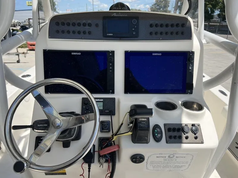 Slide: The Image of Control panel of a 2016 Avenger AV 26 boat with steering wheel and navigation screens. - 9