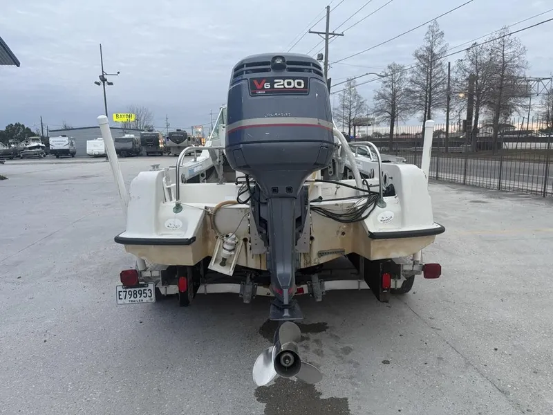 Slide: The Image of 1977 Boston Whaler 21 REVENGE with V6 200 outboard motor, parked on a trailer. - 10