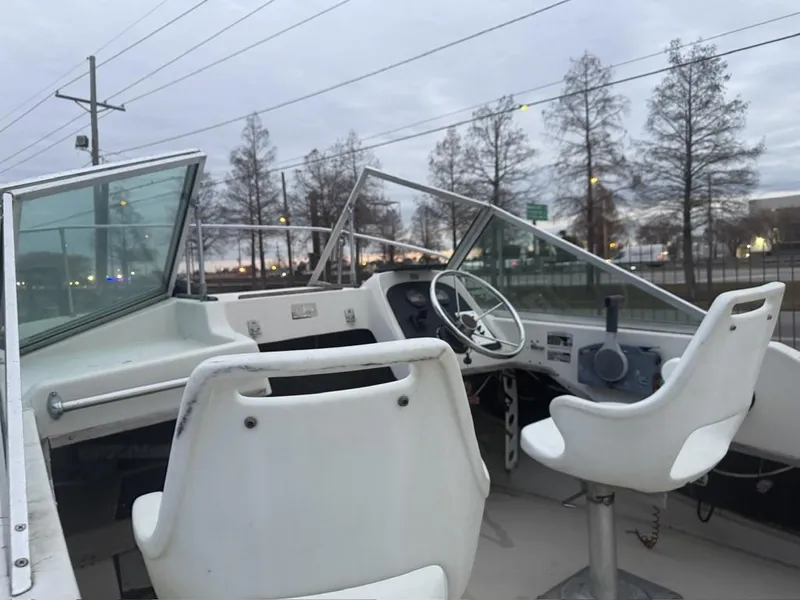 Slide: The Image of 1977 Boston Whaler 21 REVENGE boat interior with steering wheel and seats. - 12