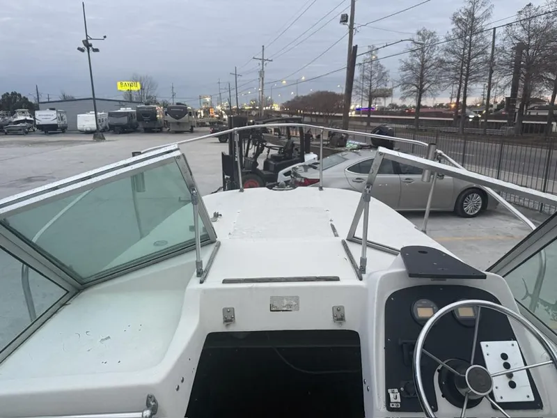 Slide: The Image of 1977 Boston Whaler 21 REVENGE boat in parking lot, view from helm. - 2