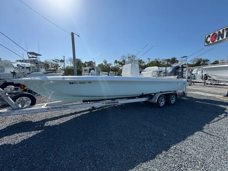 Slide: The Image of 2023 Contender 25 Bay boat on trailer in outdoor dealership lot. - 2