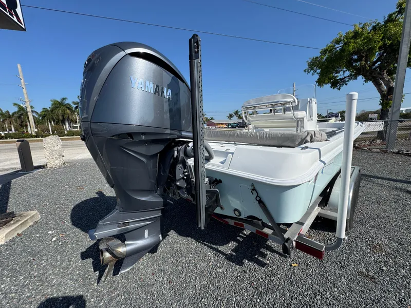 Slide: The Image of 2023 Contender 25 Bay boat with Yamaha outboard engine on a gravel lot. - 4