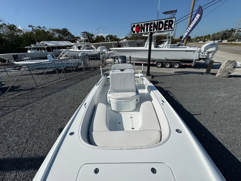 Slide: The Image of 2023 Contender 25 Bay boat displayed outdoors at a dealership. - 9