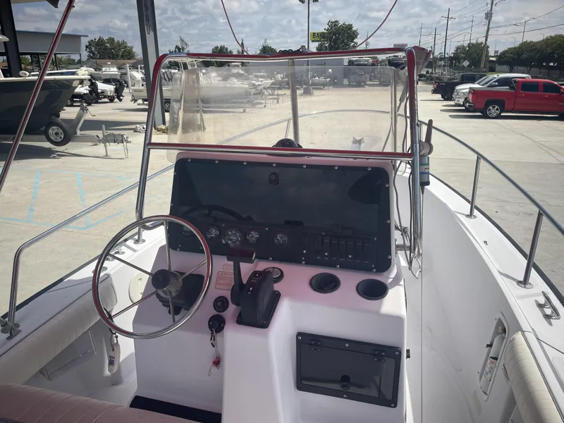 Slide: The Image of 1997 Boston Whaler 21 Outrage boat console with steering wheel and gauges. - 10