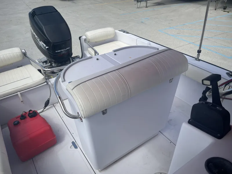 Slide: The Image of 1997 Boston Whaler 21 Outrage boat interior with Mercury engine and seating. - 14