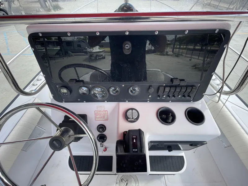 Slide: The Image of 1997 Boston Whaler 21 Outrage boat dashboard with steering wheel and control panel. - 15