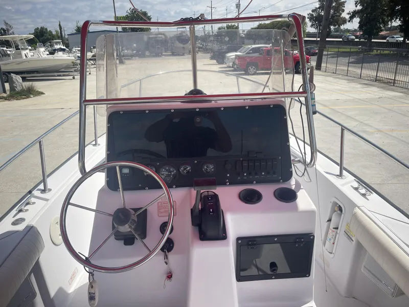 Slide: The Image of 1997 Boston Whaler 21 Outrage boat dashboard with steering wheel and controls. - 20