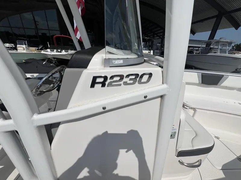 Slide: The Image of 2023 Robalo 230 boat interior with steering wheel and seating area. - 13