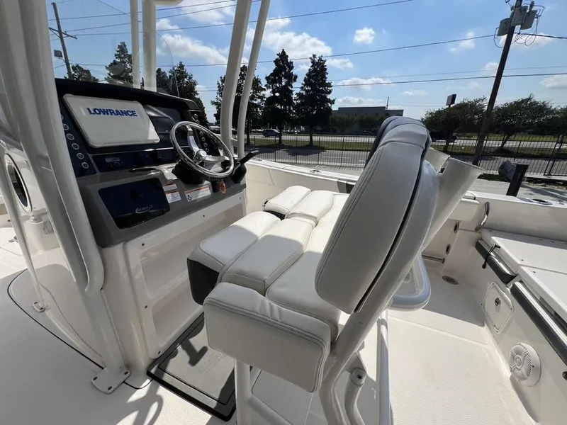 Slide: The Image of 2023 Robalo 230 boat interior with steering console and seating, featuring Lowrance equipment. - 20