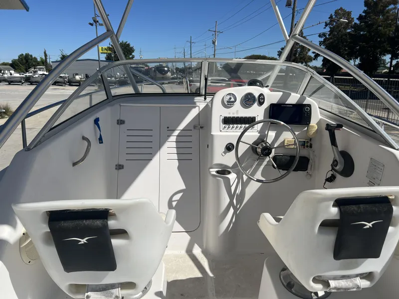 Slide: The Image of 2007 Pro-Line 21 WA boat with T-top and console, parked outdoors. - 5