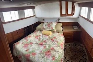 Slide: The Image of Cozy bedroom in 1989 Grand Banks GND01 yacht with floral bedding and wooden cabinetry. - 3