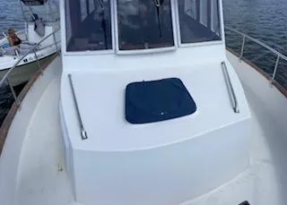 Slide: The Image of 1989 Grand Banks GND01 boat deck with hatch, docked on calm water. - 5