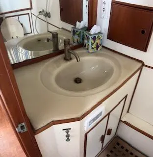 Slide: The Image of 1989 Grand Banks GND01 yacht bathroom with sink, mirror, and wooden accents. - 7
