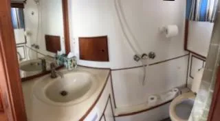 Slide: The Image of 1989 Grand Banks GND01 yacht bathroom with sink, mirror, and toilet. - 9