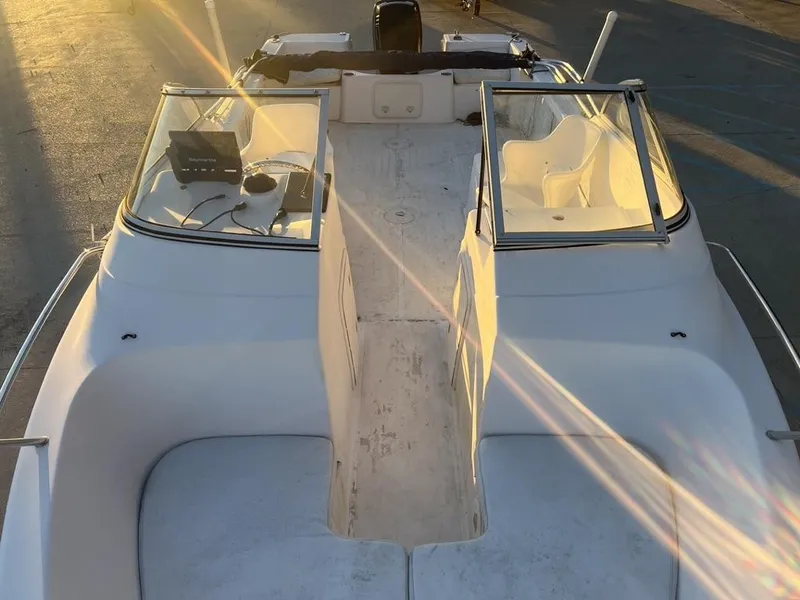 Slide: The Image of 2002 Pro-Line 22DC boat interior with dual consoles and seating, illuminated by sunlight. - 5