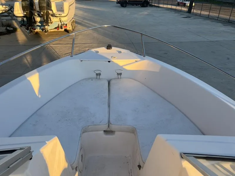 Slide: The Image of 2002 Pro-Line 22DC boat deck with railing, parked on concrete surface. - 6