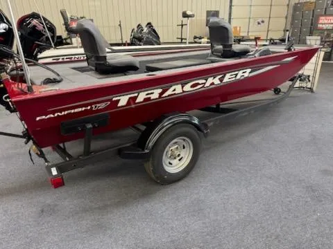 The Image of 2025 Tracker Panfish 17 boat, red with dual seats, displayed indoors. - 0