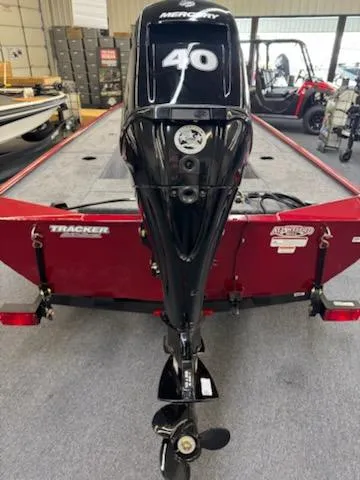 Slide: The Image of 2025 Tracker Panfish 17 boat with Mercury 40 outboard motor, displayed indoors. - 2