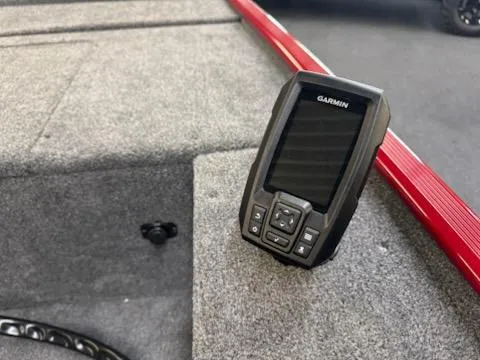 Slide: The Image of 2025 Tracker Panfish 17 boat with Garmin fishfinder on carpeted deck. - 8