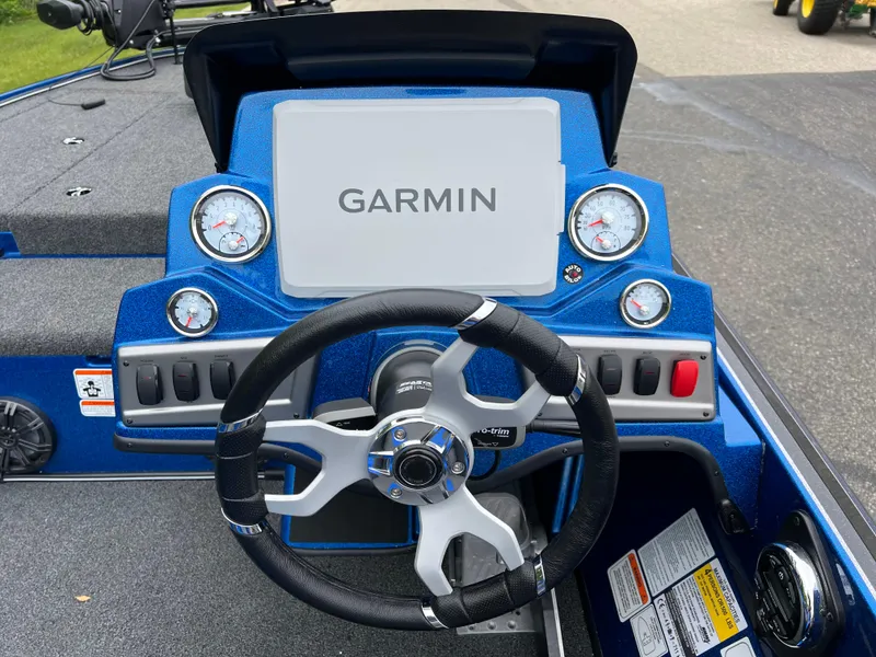 Slide: The Image of 2025 Nitro Z19 Pro boat interior with blue and gray seating, steering wheel, and motor. - 7