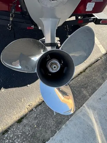 Slide: The Image of Propeller of 2025 Tracker Savage 215 boat, shiny metal blades, parked on pavement. - 3