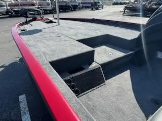 Slide: The Image of 2025 Tracker Savage 215 boat interior with red trim, spacious deck, and storage compartments. - 6