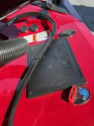 Slide: The Image of Close-up of 2025 Tracker Savage 215 boat dashboard with cables and controls. - 9