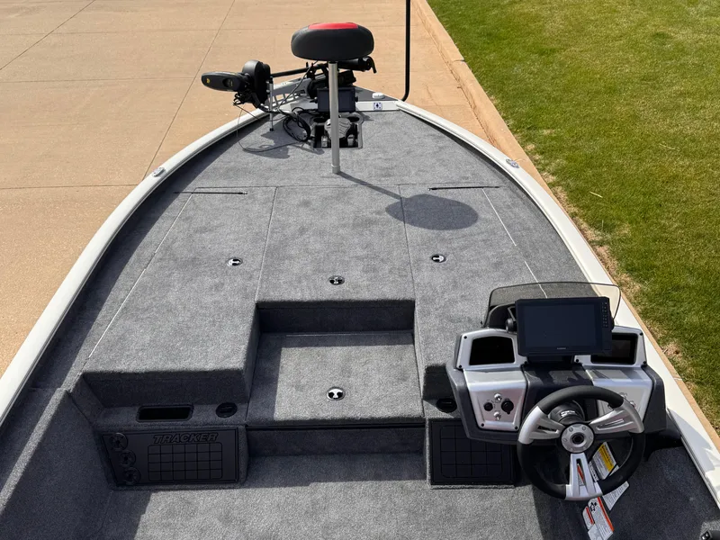 Slide: The Image of 2025 Tracker Savage 215 boat interior with steering console and fishing seat. - 2