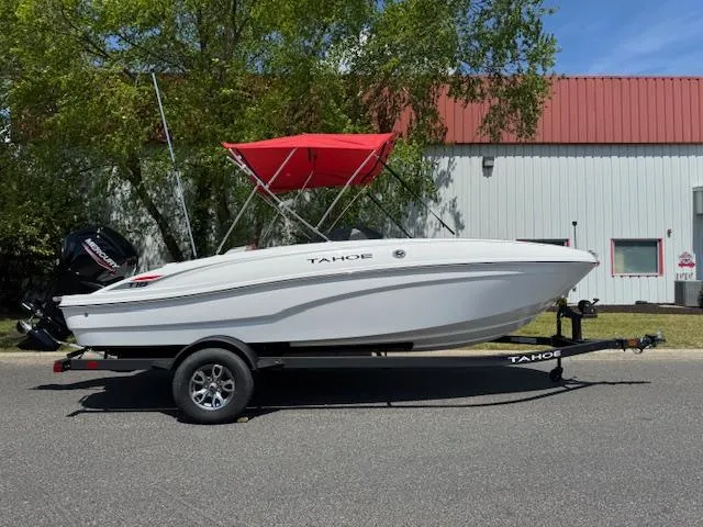 The Image of 2025 Tahoe T18 boat with red canopy on trailer, parked outdoors. - 0
