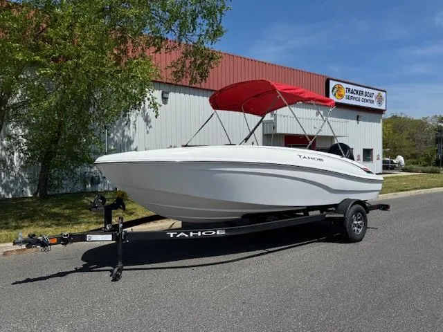Slide: The Image of 2025 Tahoe T18 boat with red canopy on trailer outside service center. - 3