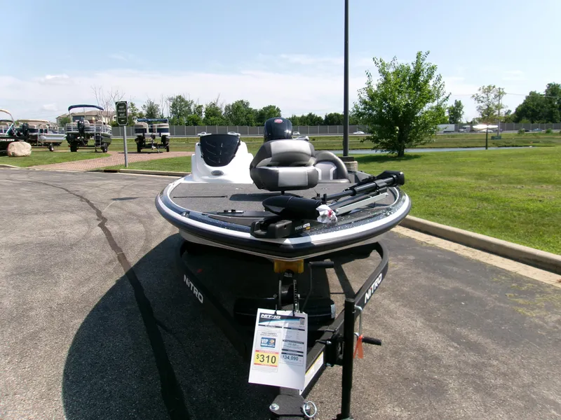 Slide: The Image of 2025 Nitro Z17 boat displayed outdoors on a sunny day, showcasing sleek design and features. - 2