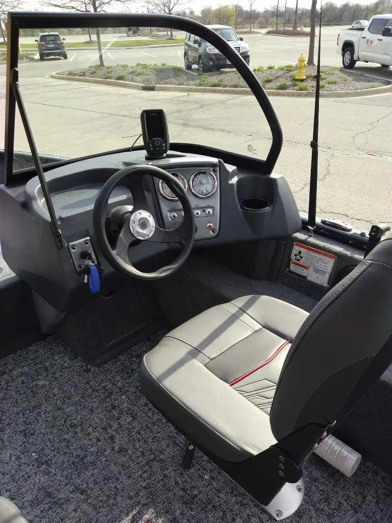 Slide: The Image of 2025 Tracker Pro Guide V-16 WT boat interior with steering wheel and dashboard controls. - 2
