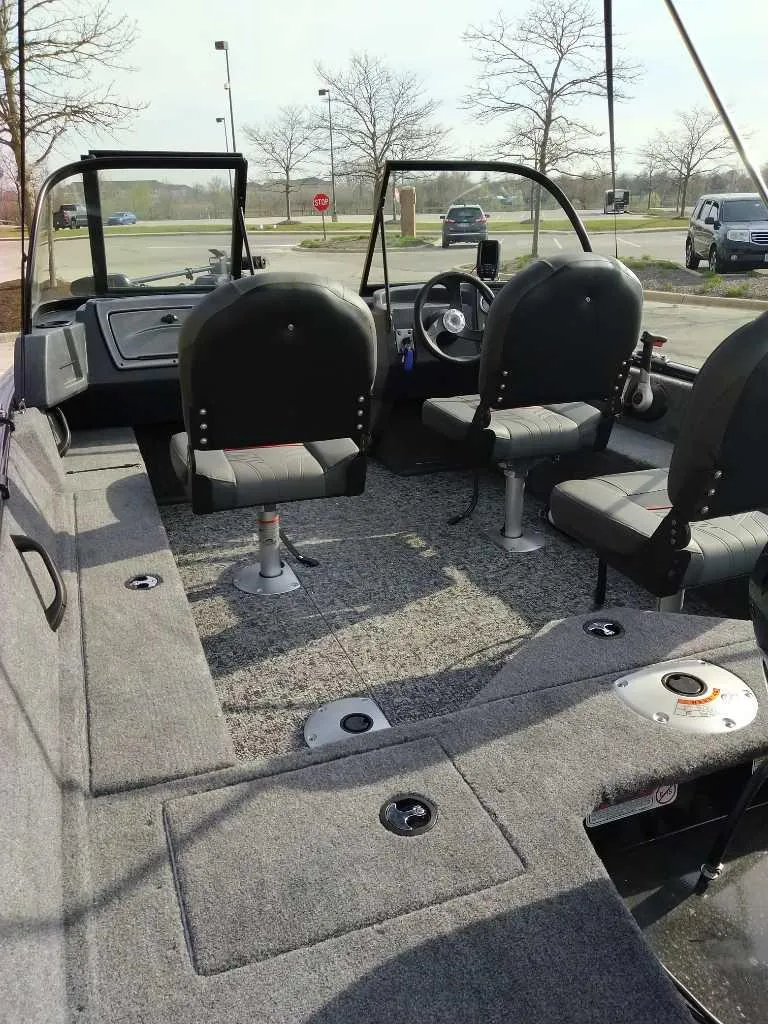 Slide: The Image of 2025 Tracker Pro Guide V-16 WT boat interior with seating and steering wheel. - 3