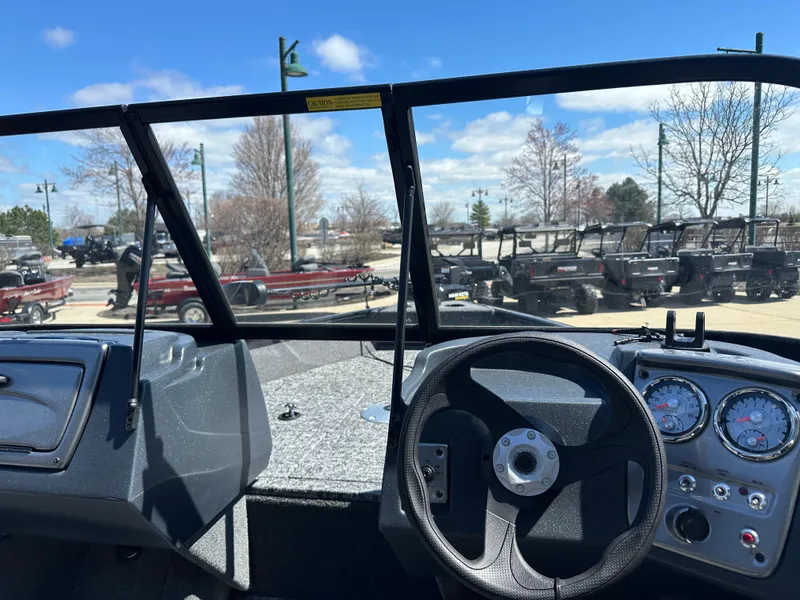Slide: The Image of 2025 Tracker Pro Guide V-16 WT boat interior with steering wheel and dashboard gauges. - 3