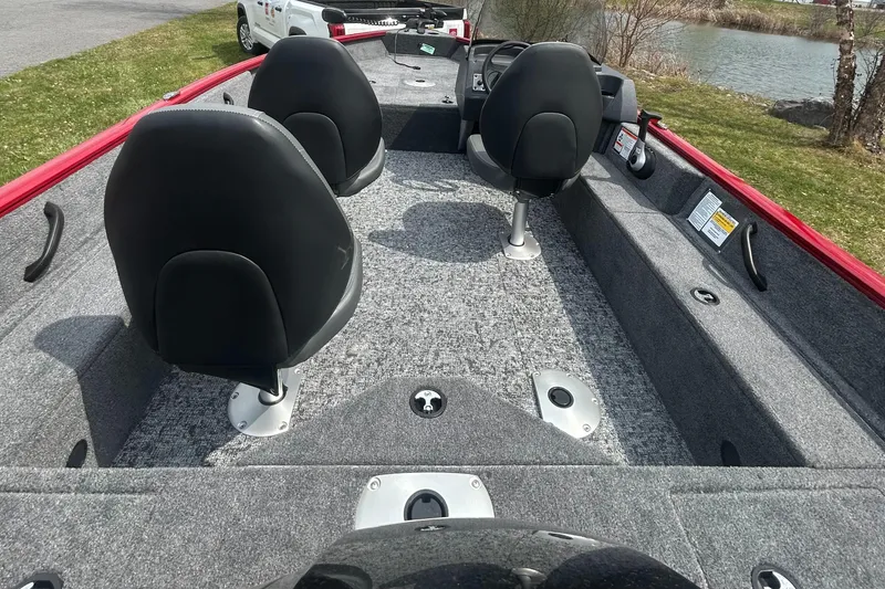 Slide: The Image of 2025 Tracker Pro Guide V-16 SC boat interior with seating and carpeted deck. - 4