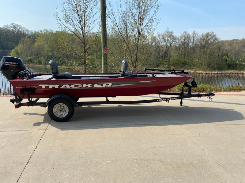 The Image of 2025 Tracker Panfish 17 boat on trailer, parked near a scenic lake. - 0