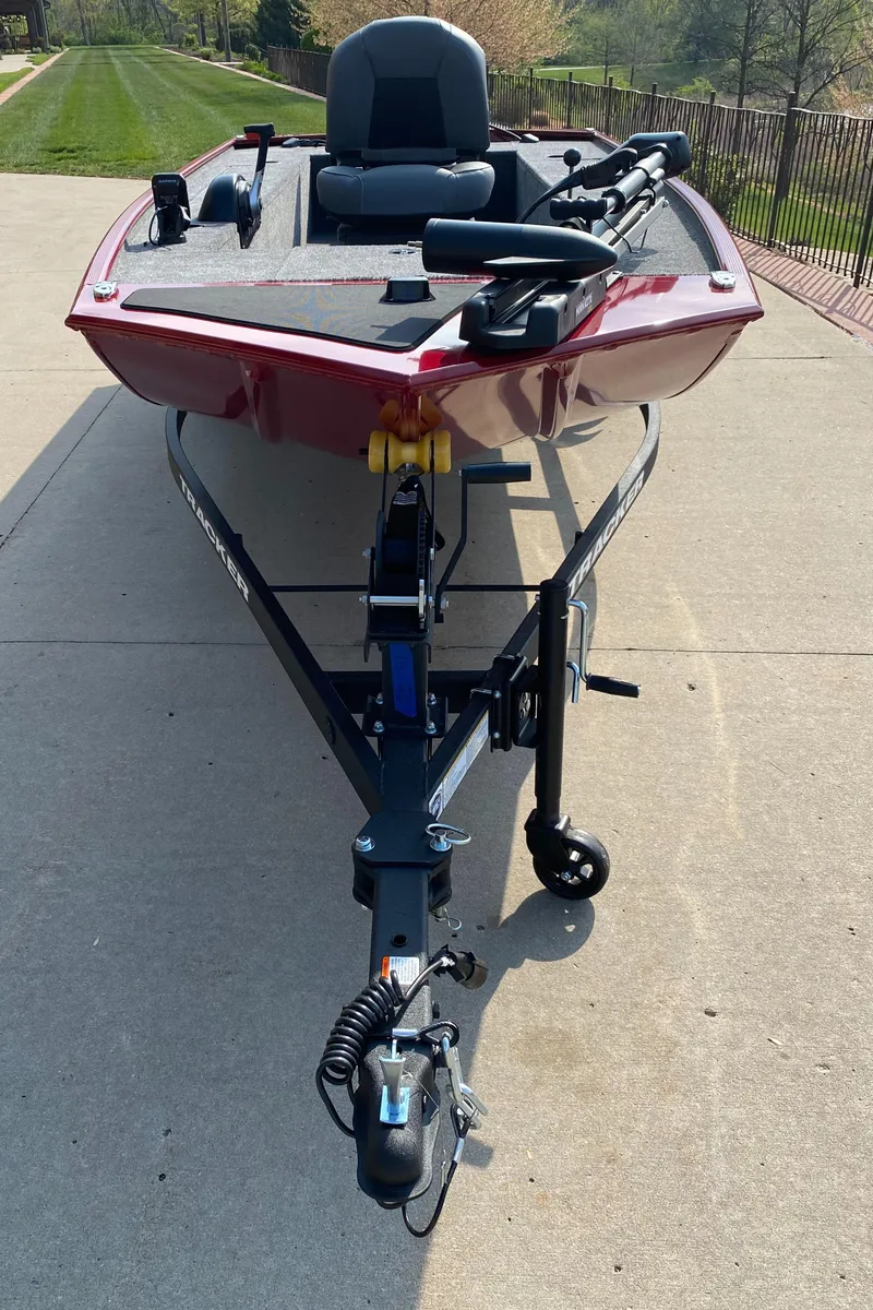 Slide: The Image of 2025 Tracker Panfish 17 boat on trailer, parked on concrete driveway. - 2