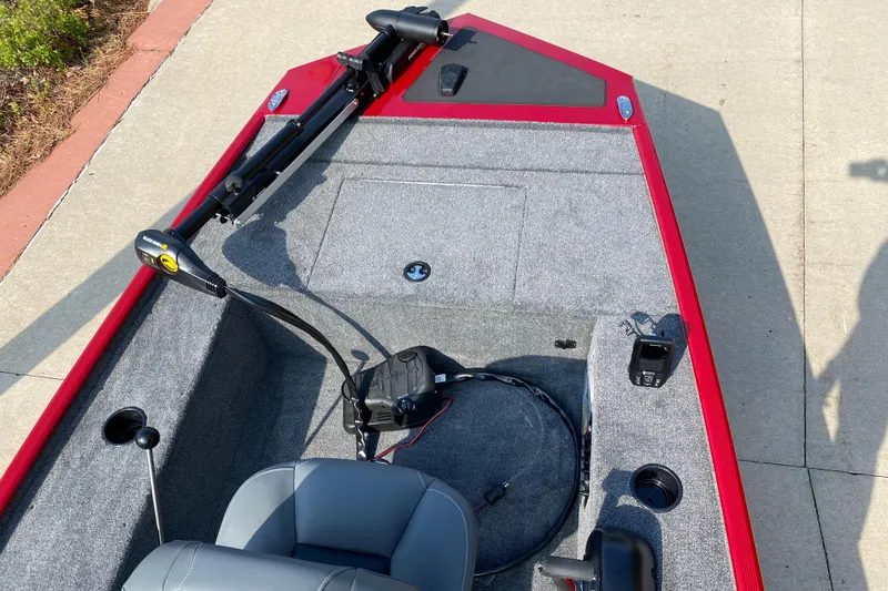 Slide: The Image of 2025 Tracker Panfish 17 boat with red trim and gray interior, featuring a trolling motor. - 3