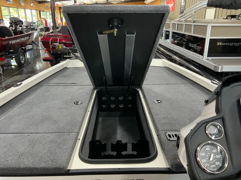 Slide: The Image of 2025 Ranger RT188 boat interior with open storage compartment and dashboard gauges. - 10