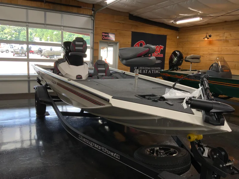Slide: The Image of 2025 Ranger RT188 boat in showroom, featuring sleek design and modern seating. - 2