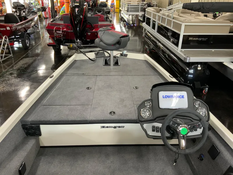 Slide: The Image of 2025 Ranger RT188 boat interior with Lowrance system, steering wheel, and seating in showroom. - 6