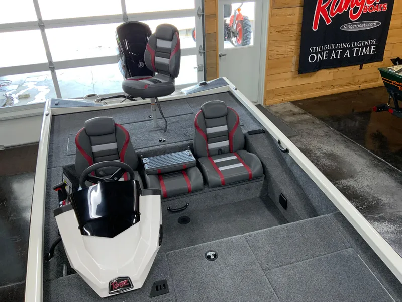 Slide: The Image of 2025 Ranger RT188 boat interior with gray and red seating, steering console, and carpeted flooring. - 8