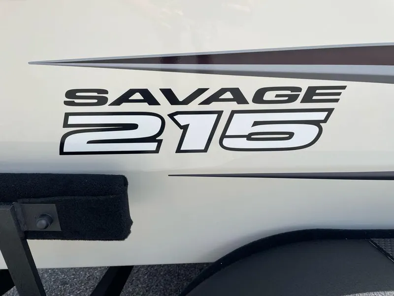 Slide: The Image of 2025 Tracker Savage 215 boat logo on white surface. - 2