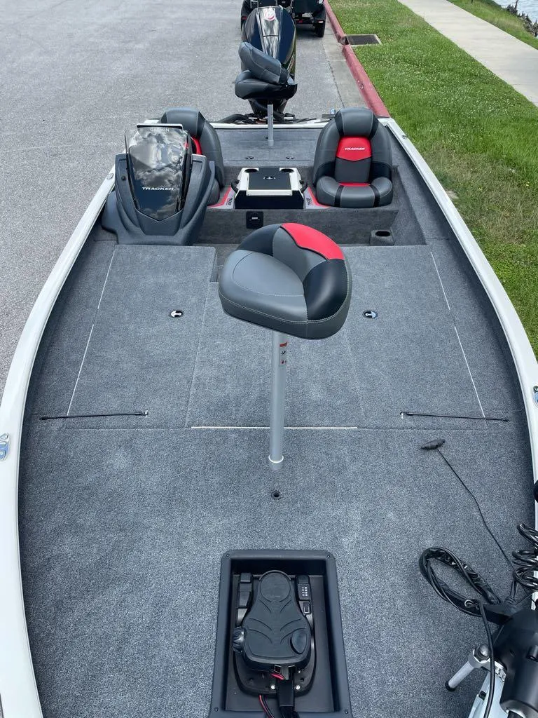 Slide: The Image of 2025 Tracker Savage 215 boat interior with seating and fishing equipment. - 3