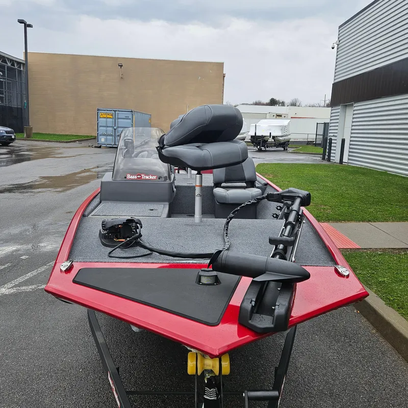 Slide: The Image of 2025 Tracker Bass Tracker Classic XL boat with red exterior, parked outdoors. - 5