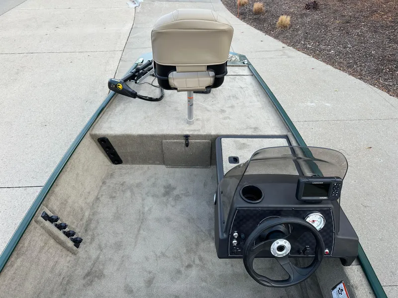 Slide: The Image of 2025 Tracker Bass Tracker Classic Limited boat interior with steering console and seating. - 4